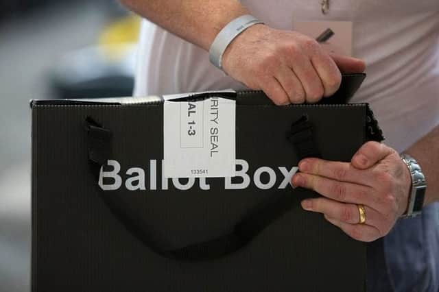 A member of the count staff opens a sealed ballot boxes containing voting slips  (Photo: Getty Images)